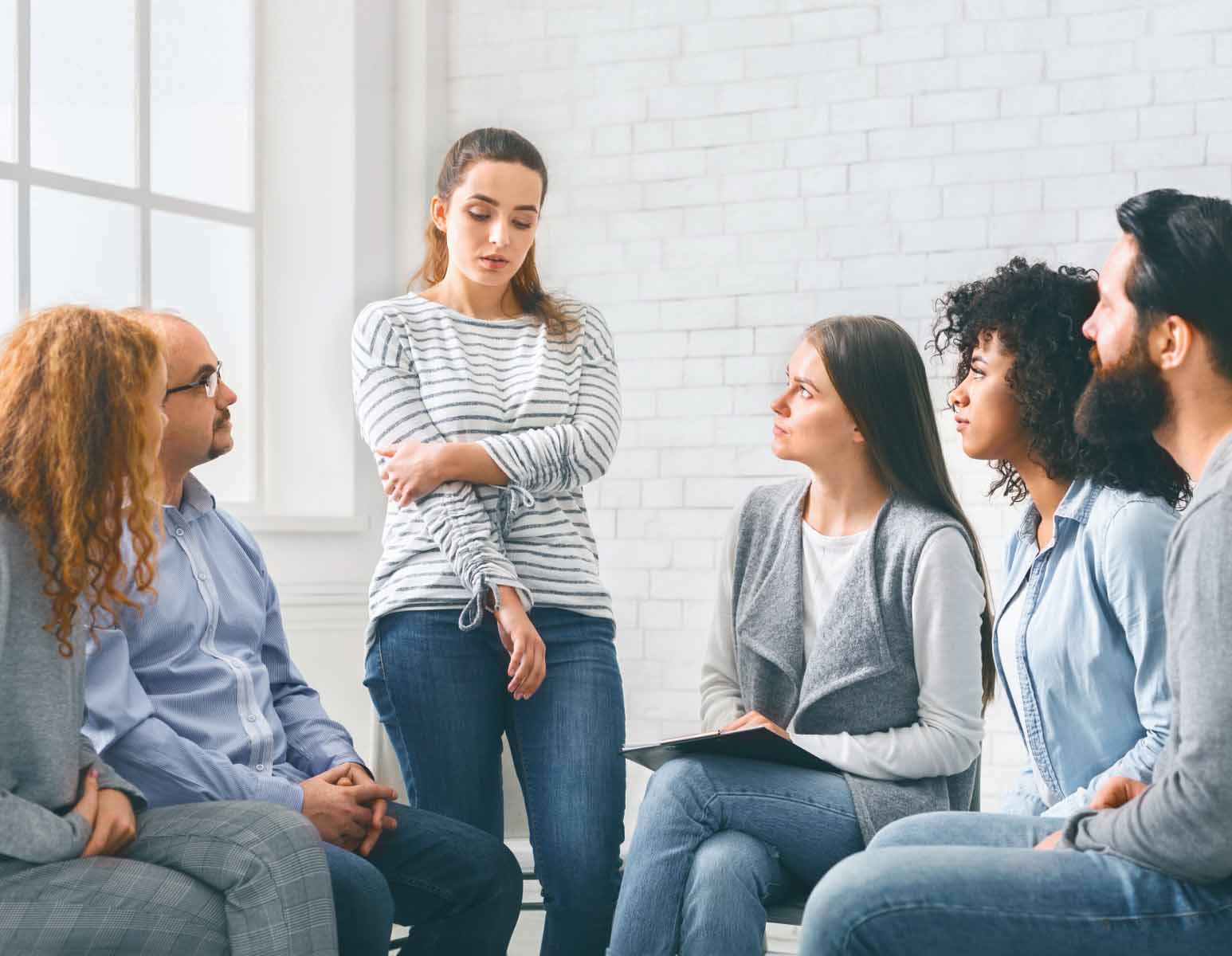 Woman standing to speak in discussion group