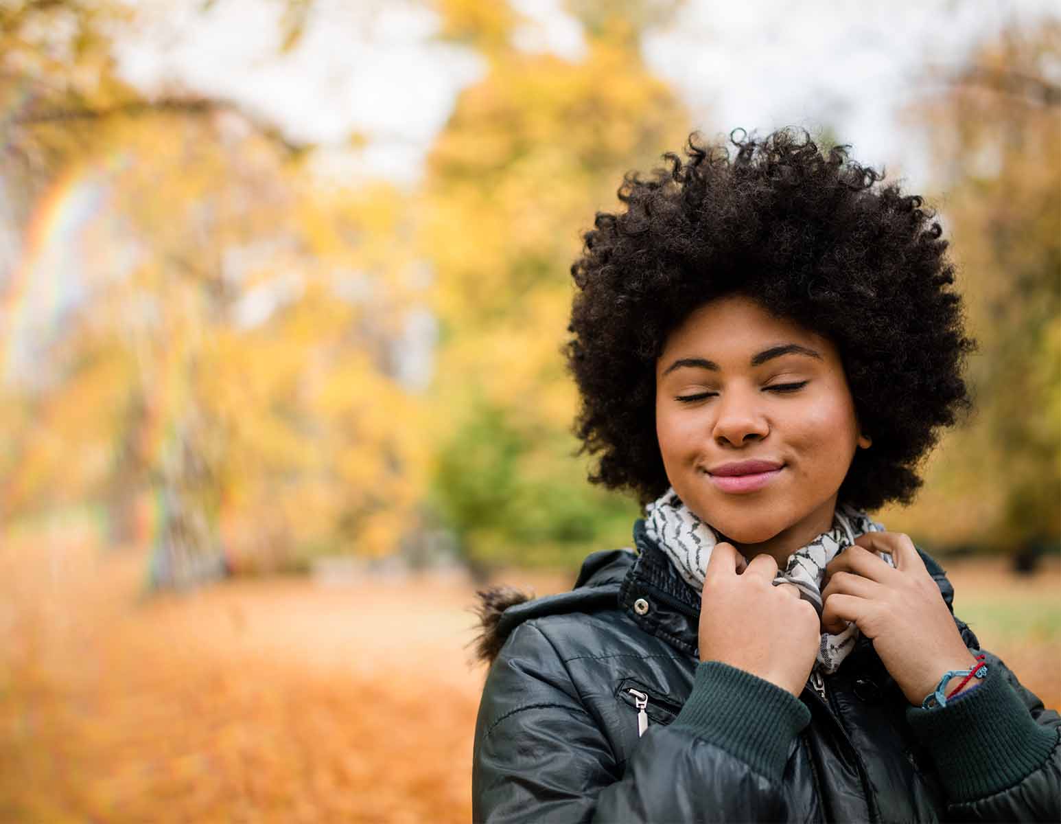 Woman smiling outdoors in autumn