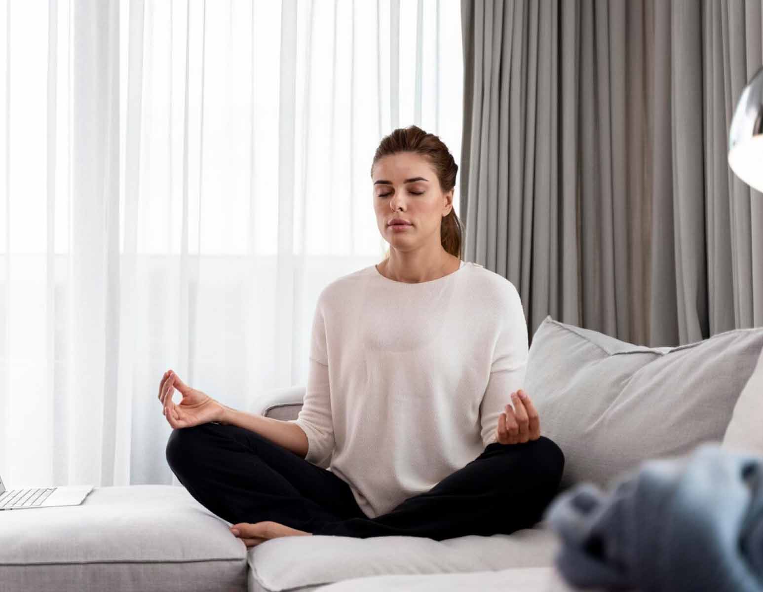 Woman meditating on couch