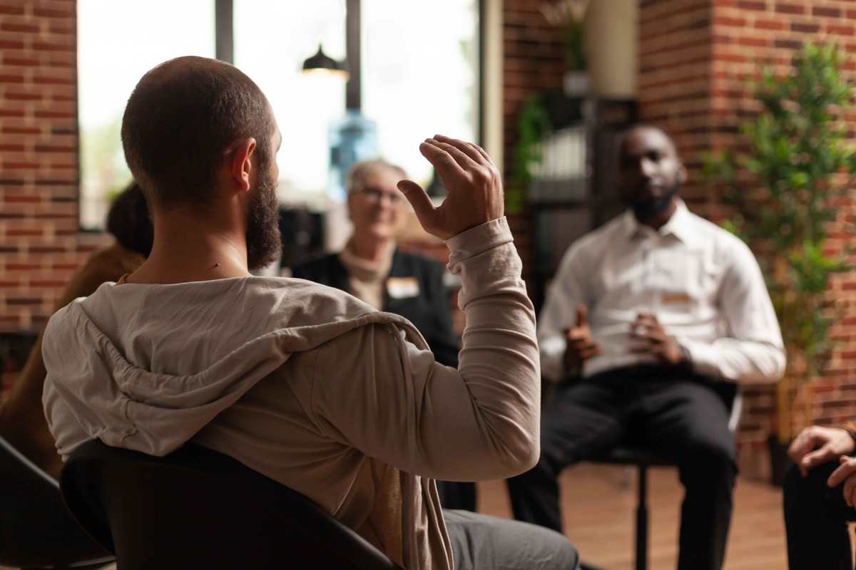 man sharing in group therapy