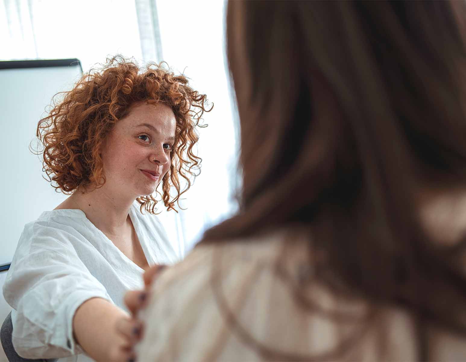 Woman touching shoulder of fellow discussion group member