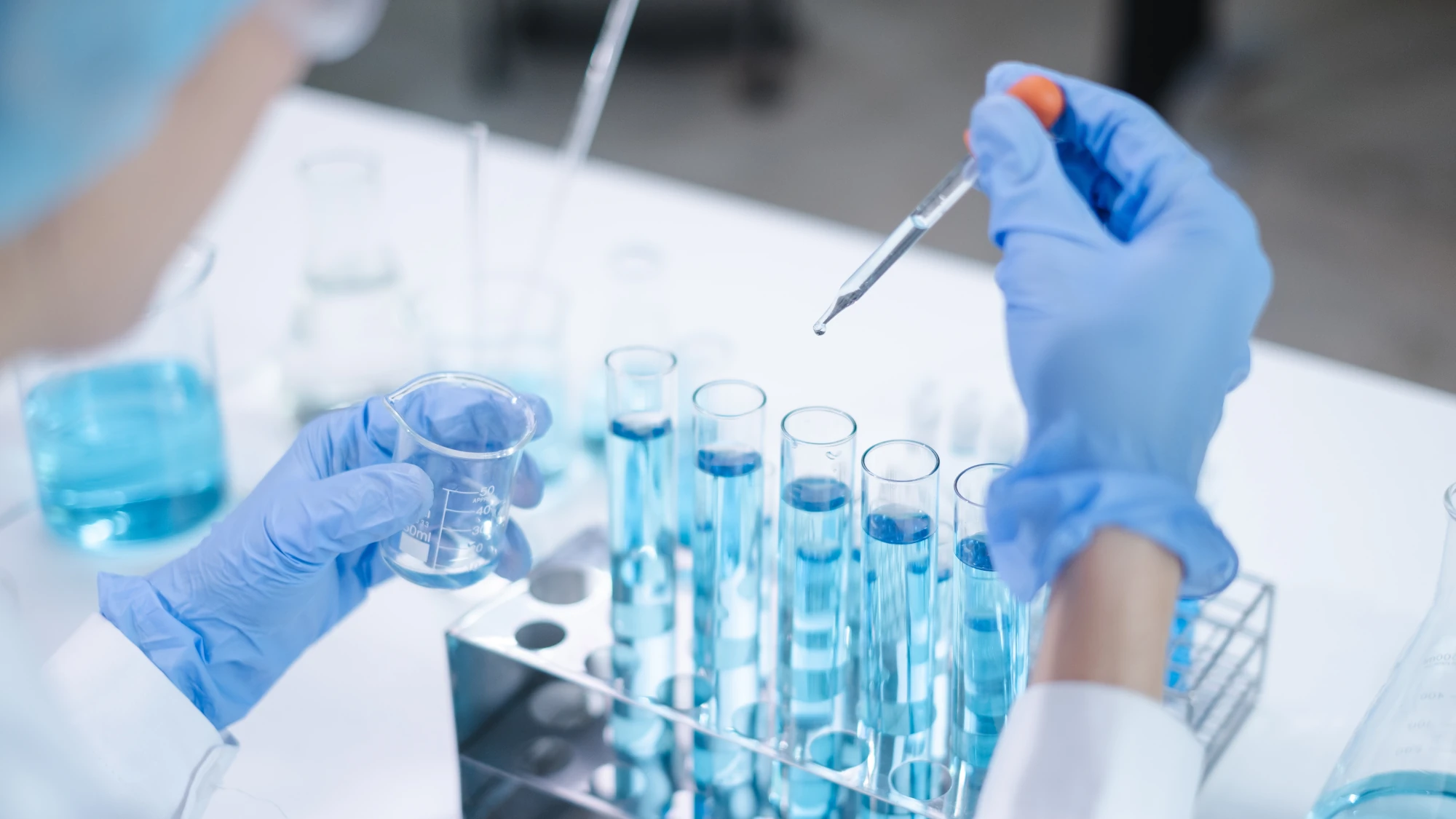 Lab technician labeling a urine sample cup for an HEB pre-employment drug test.